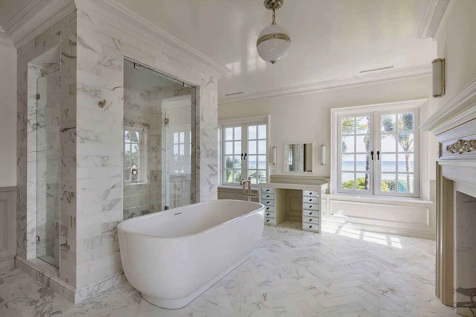 Marble bath with a freestanding tub and a glass shower