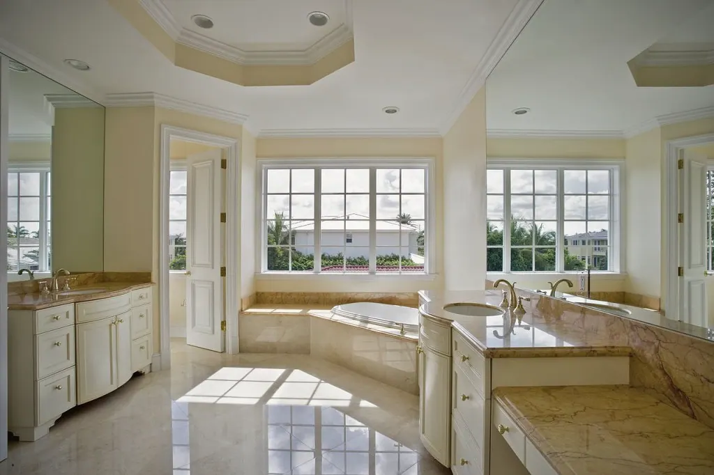 Primary bath with a soaking tub under a wall of windows