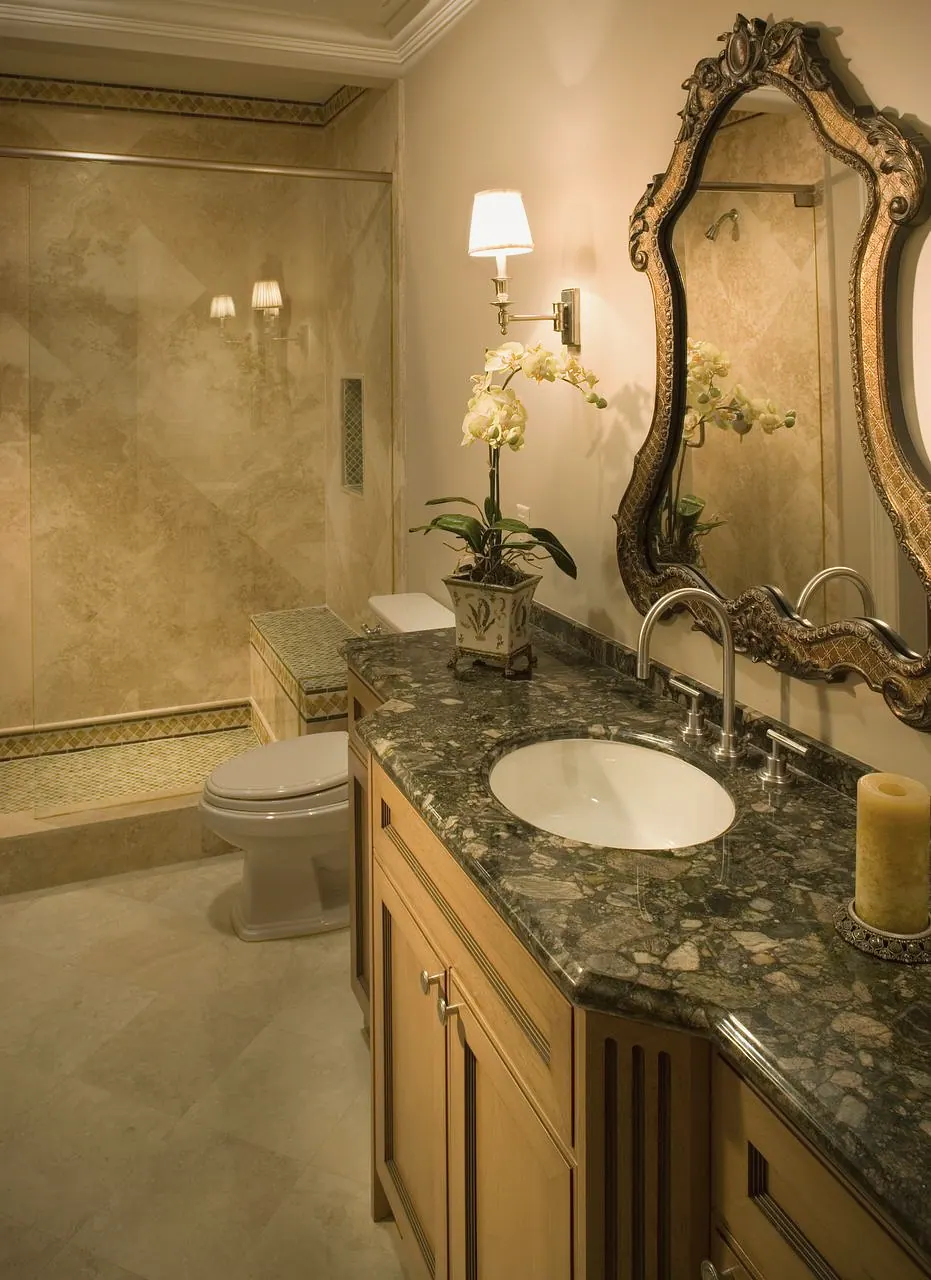 Powder room with a carved mirror and a stone vanity