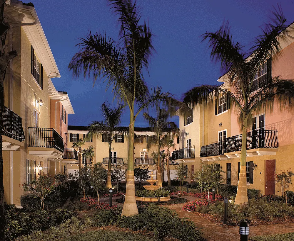 Residential courtyard with palms at dusk