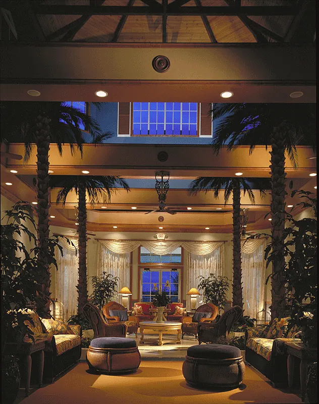 Lobby lounge under a skylight, lit in the evening