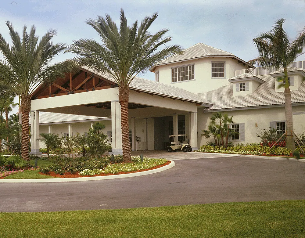 Porte cochere of a clubhouse with palms