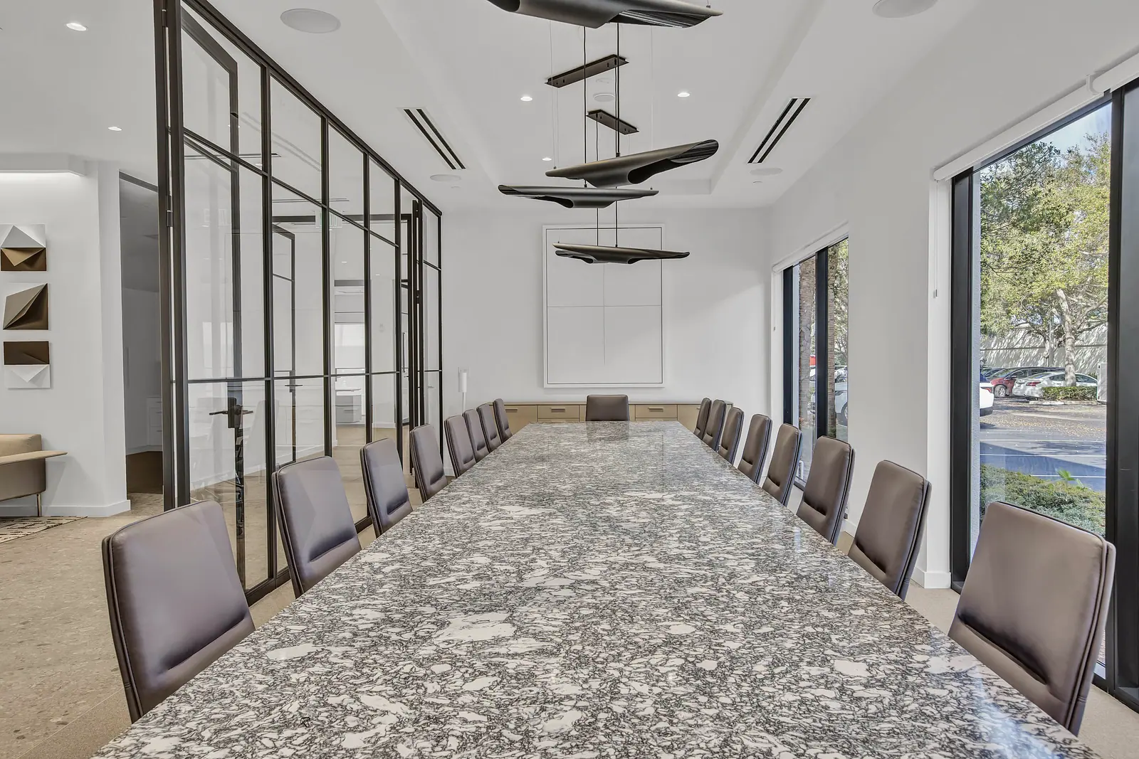 Boardroom with a long stone table and glass partitions