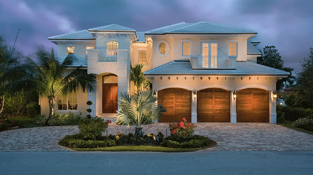 Mediterranean house at dusk with a paver motor court