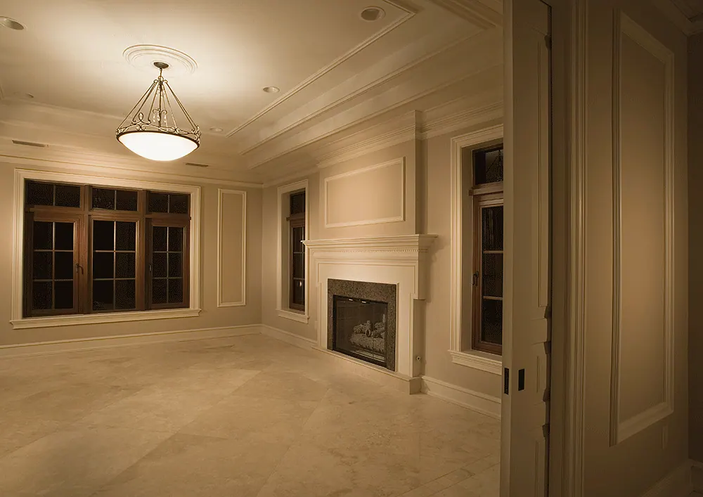 Paneled study with a fireplace and dark wood windows