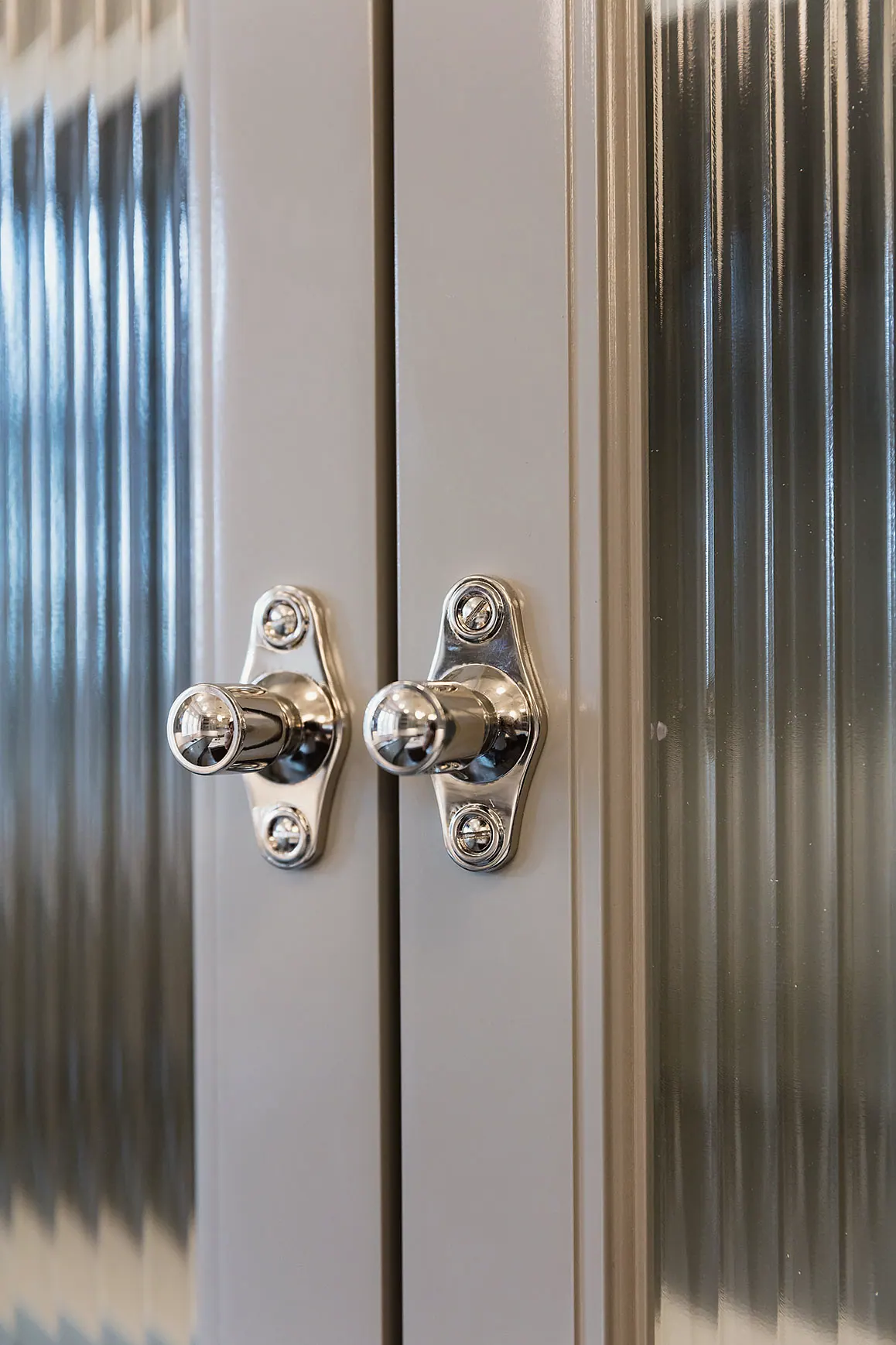 Reeded glass cabinet doors with nickel latches