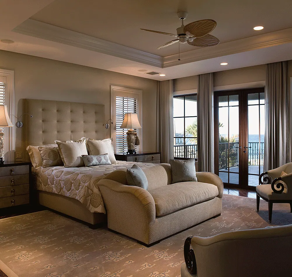 Bedroom with a tufted headboard, a tray ceiling and French doors to a balcony