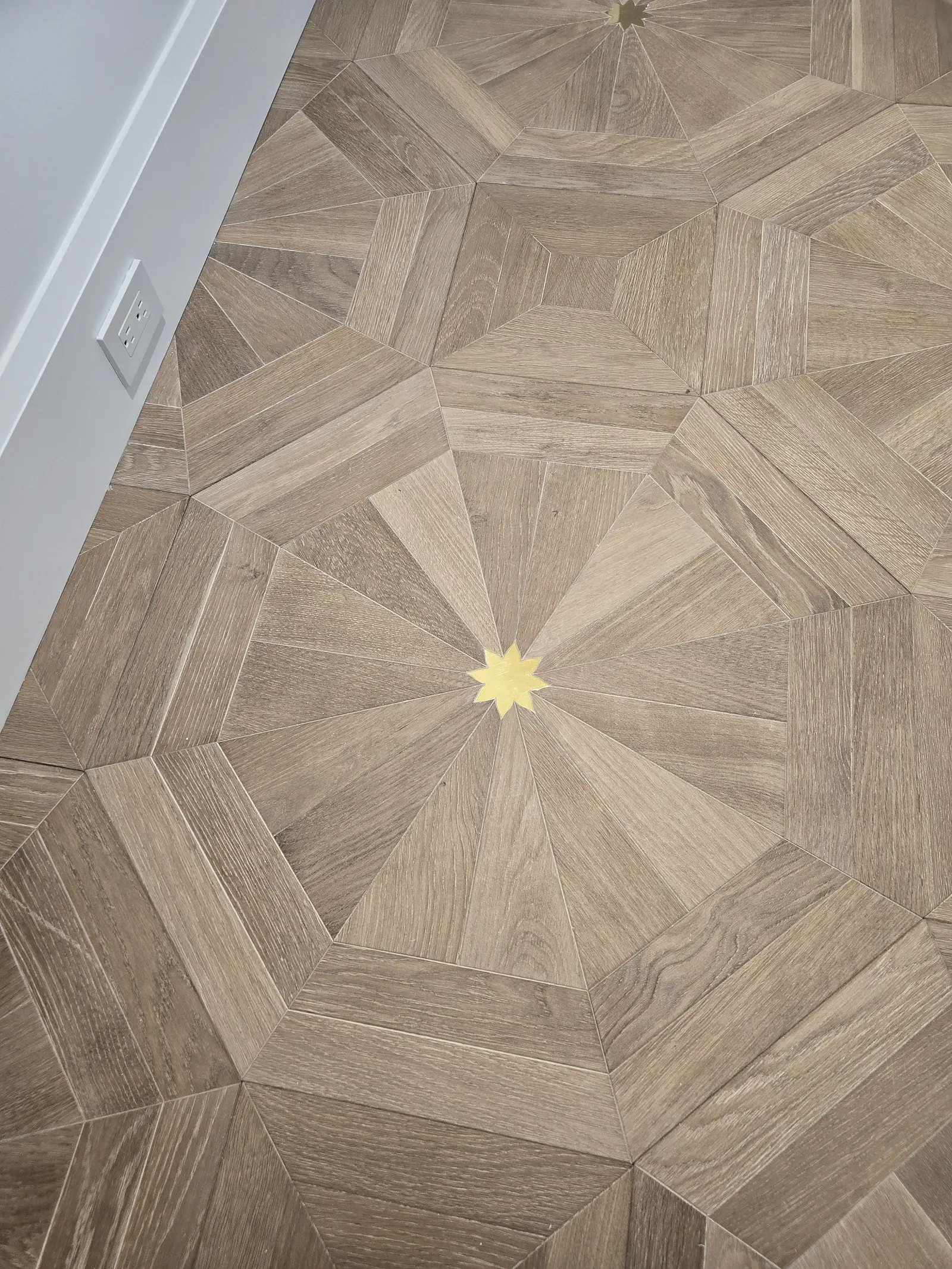 Octagonal wood parquet floor pattern with a brass star inlay