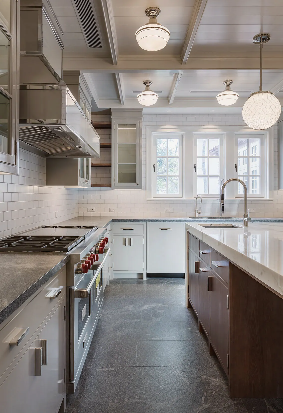 Galley of a white kitchen with a professional range