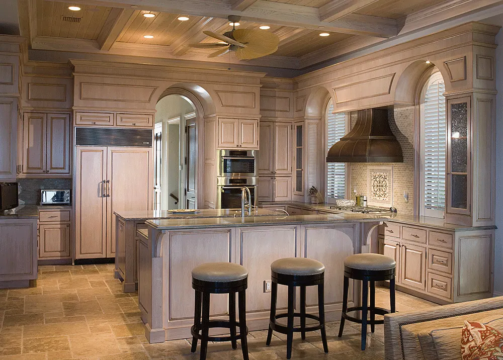 Kitchen with a coffered ceiling, a copper hood and island seating