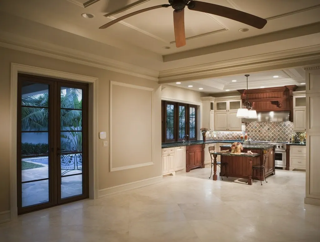 Great room opening to the kitchen, with French doors to the pool