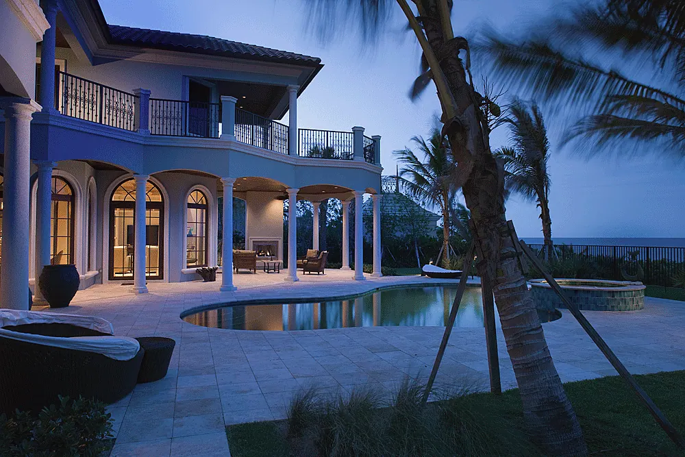 Pool and loggia of an oceanfront house at dusk