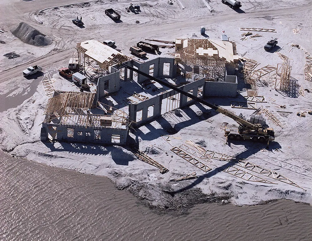 Aerial view of a house being framed on a beachfront lot