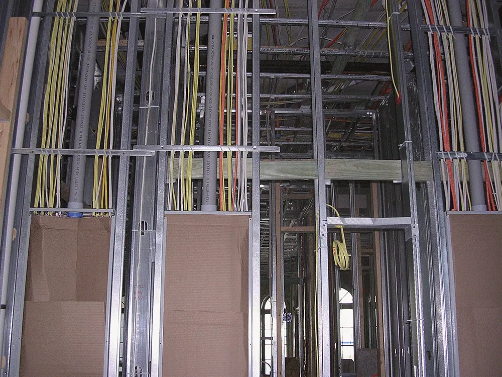 Electrical rough-in run through a steel stud wall